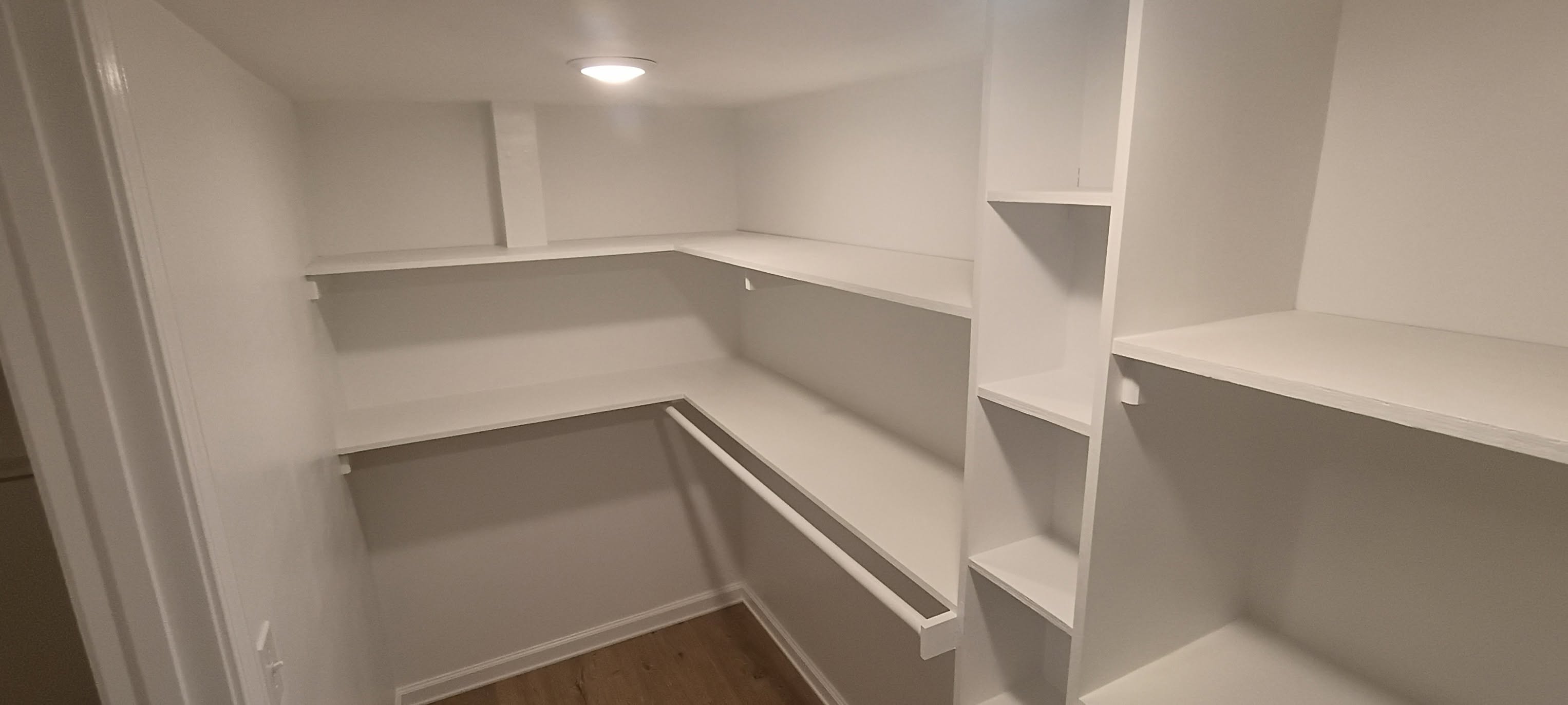 Finished walk-in closet with custom shelving in Kansas City Missouri