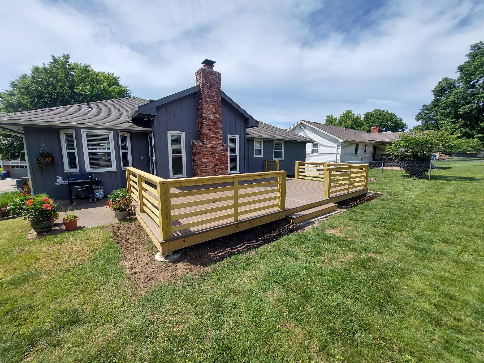 Completed elevated deck with stairs and guardrails in Liberty Missouri